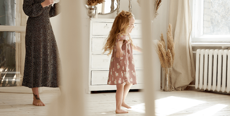 Image of a child standing infront of a heater