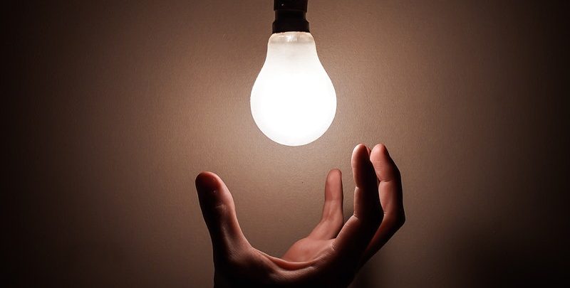 hand reaching for led light bulb