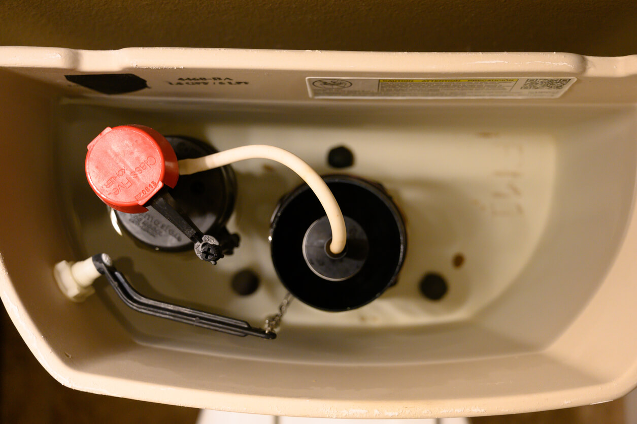 Inside water tank of toilet with float raised