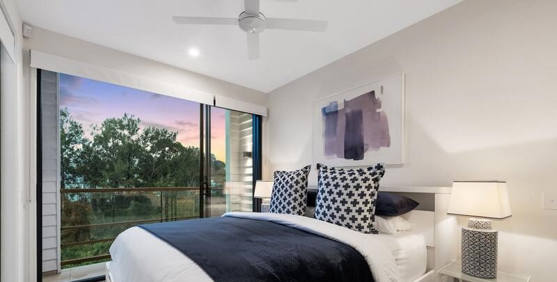 Bedroom with ceiling fan at sunset or sunrise