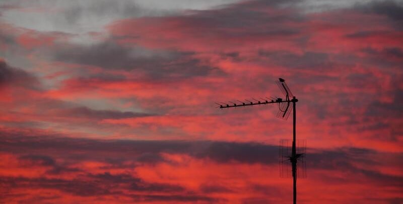 television antenna in cloudy sunset sky